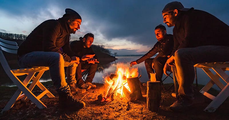Men sitting around a campfire